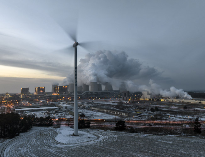 Vestas Windenergieanlage vor Kulisse LEAG Braunkohlenkraftwerk Jaenschwalde. Land Brandenburg Dezember 2022
