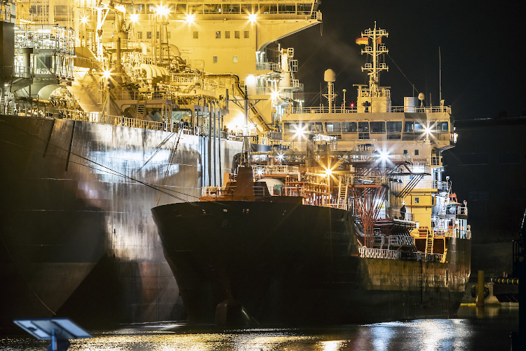 Floating LNG Terminal Neptune with Shuttle Tanker Coral Favia at Lubmin Inner Harbour. Baltic Sea Germany 2023