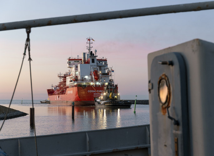 Floating LNG Terminal Neptune. Shuttle Tanker Coral Furcata tugged into Lubmin Inner Harbour. Baltic Sea Germany 2023
